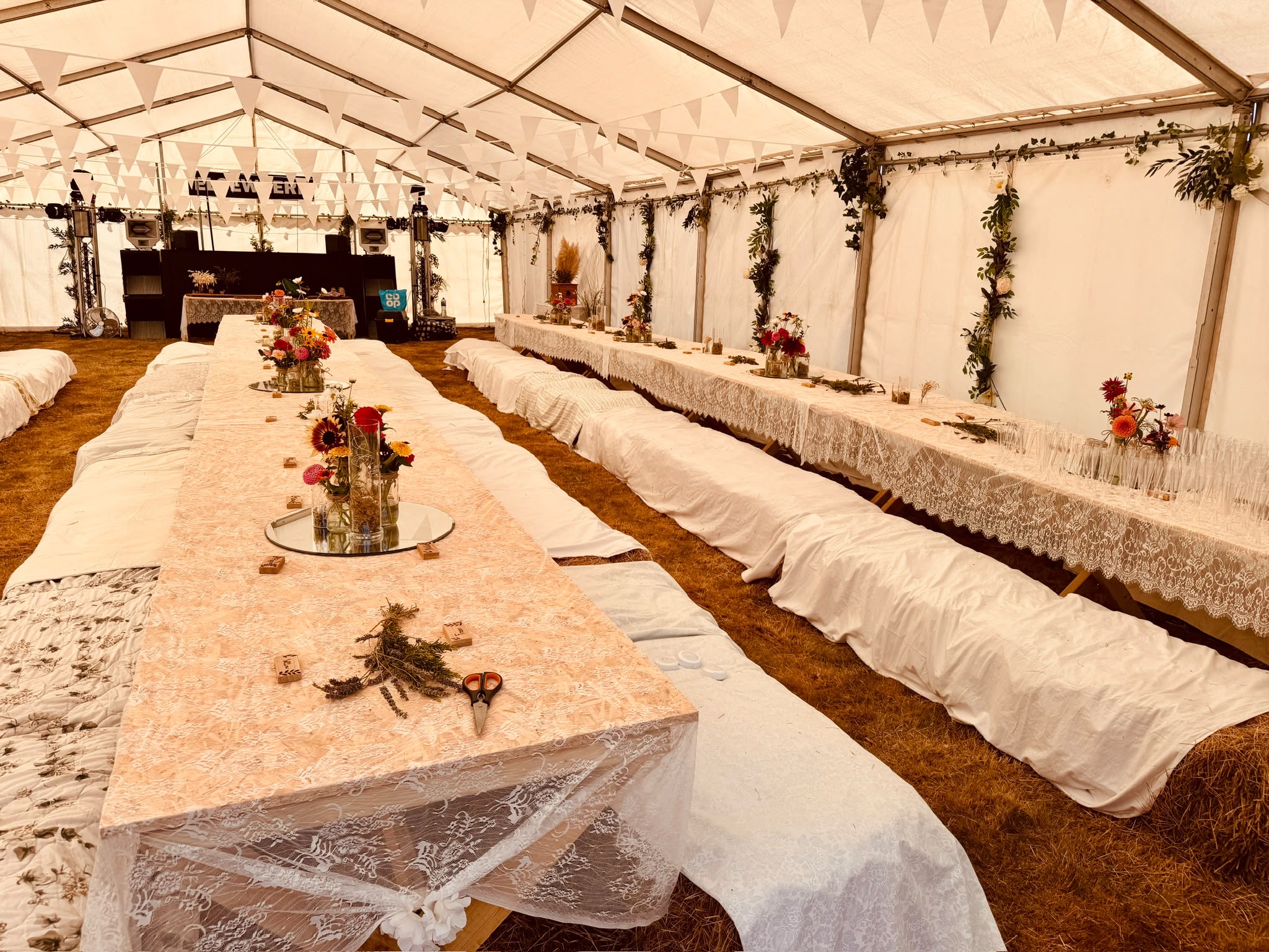 A relaxed wedding celebration beneath a marquee